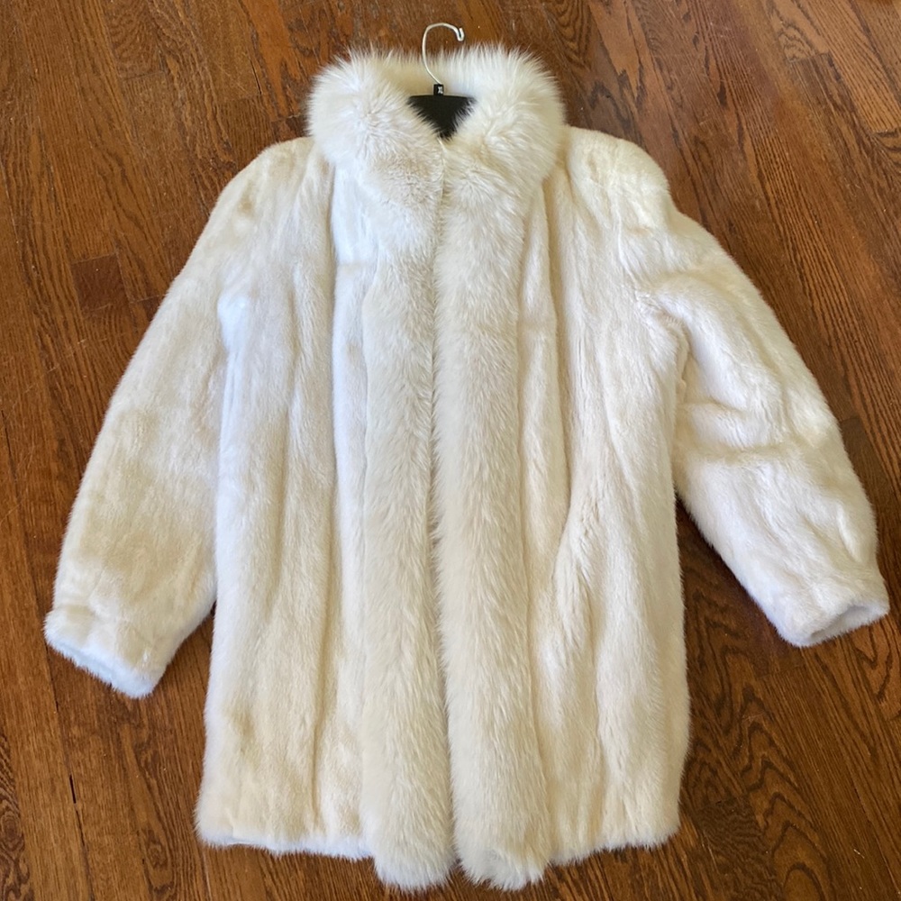 White mink coat with white fox collar and trim down front. Excellent condition.
